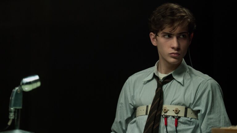 Jacob Tremblay como el joven Ted Kaczynski, conectado a un polígrafo en una sala a oscuras